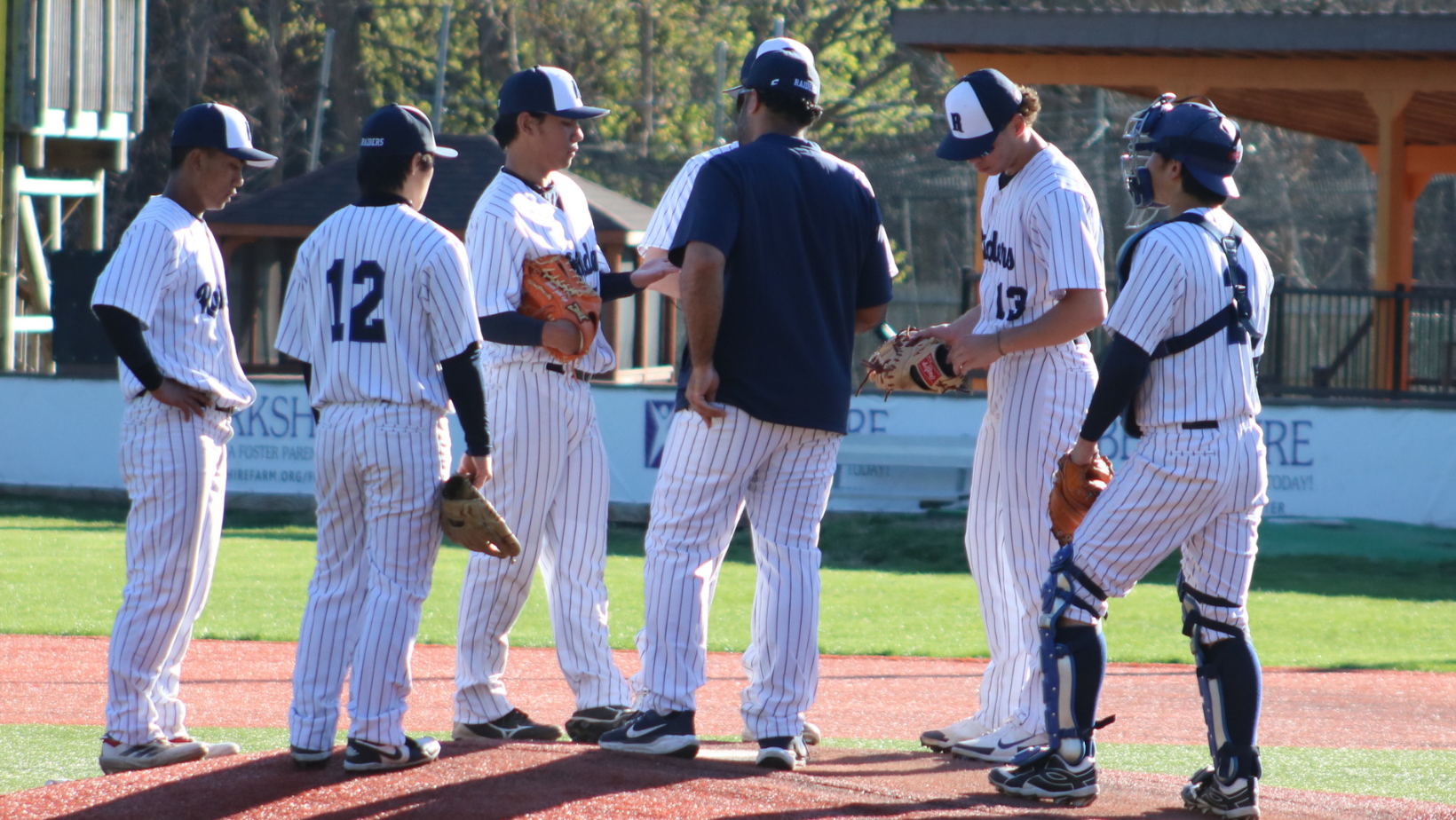 Asst. Coach Kelvyn Vasquez speaks to the team on the mound.